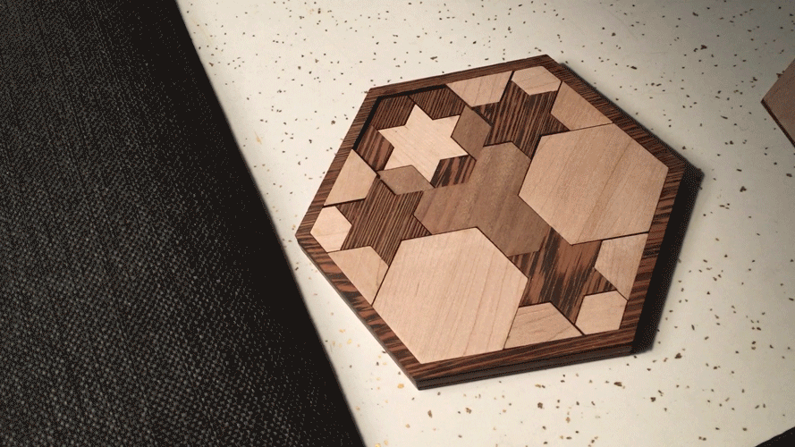 An 8-inch, hexagon-shaped puzzle made of 3 colors of hardwoods. The puzzle has 3 layers and its pieces are made up of the hexagon patterns above.